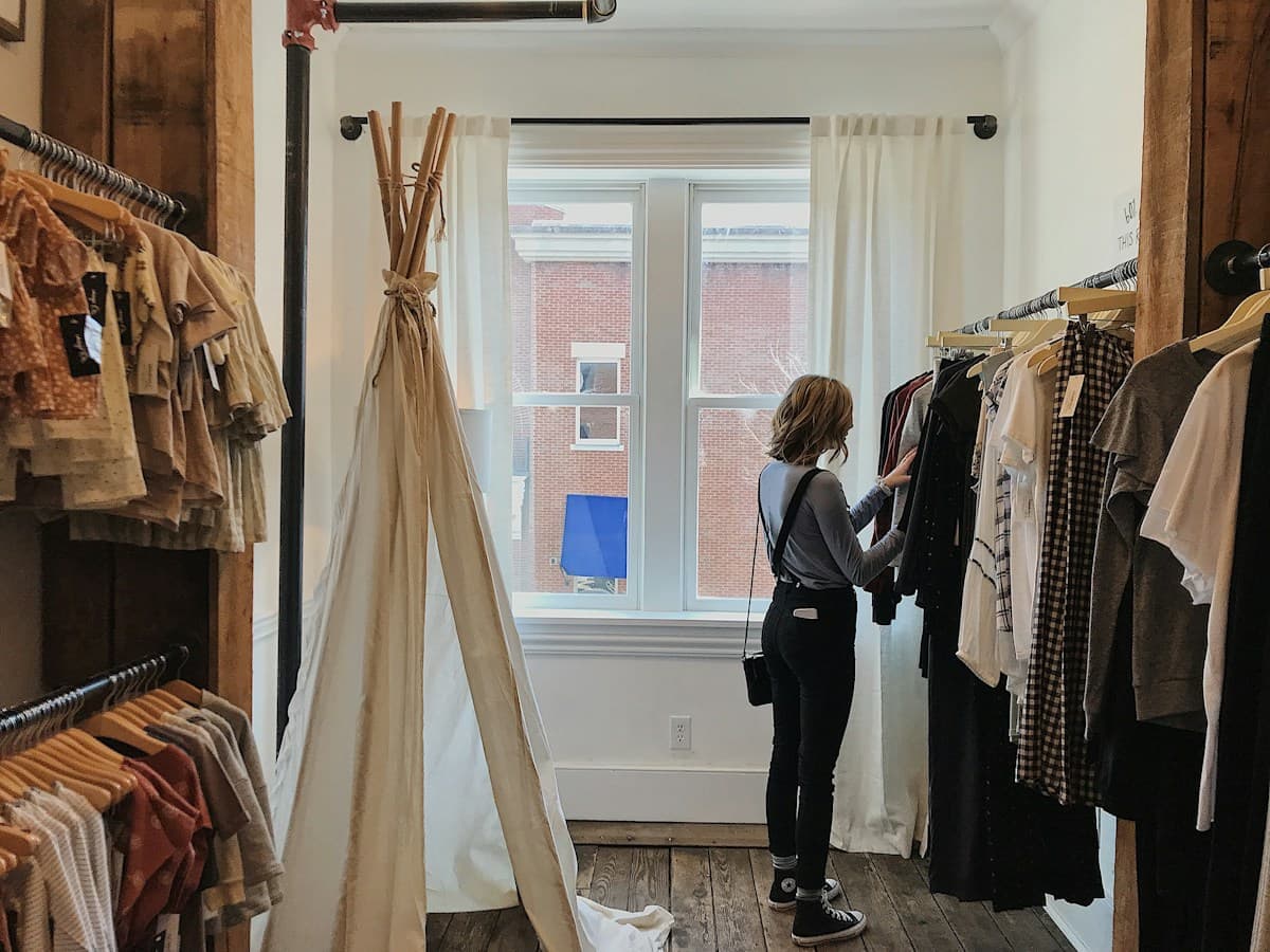 A customer choosing clothes in a shop